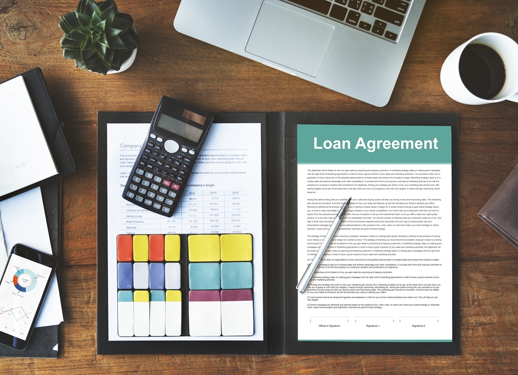Folder with a loan agreement and a calculator